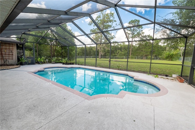 view of pool with a lanai, a lawn, and a patio