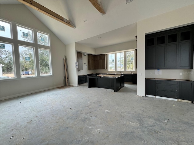 kitchen with beam ceiling and high vaulted ceiling