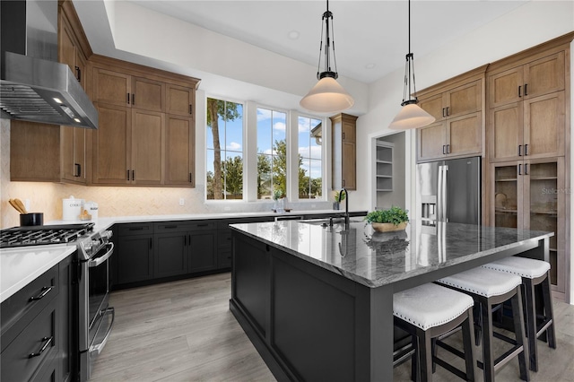 1101 SW 136th St, Newberry, FL 32669 - kitchen featuring light stone counters, stainless steel appliances, wall chimney range hood, decorative backsplash, and a breakfast bar area