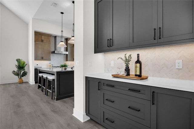 1101 SW 136th St, Newberry, FL 32669 - bar with wall chimney exhaust hood, light wood-type flooring, baseboards, visible vents, and backsplash