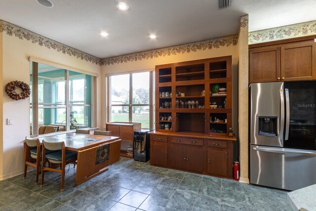 kitchen featuring stainless steel refrigerator with ice dispenser