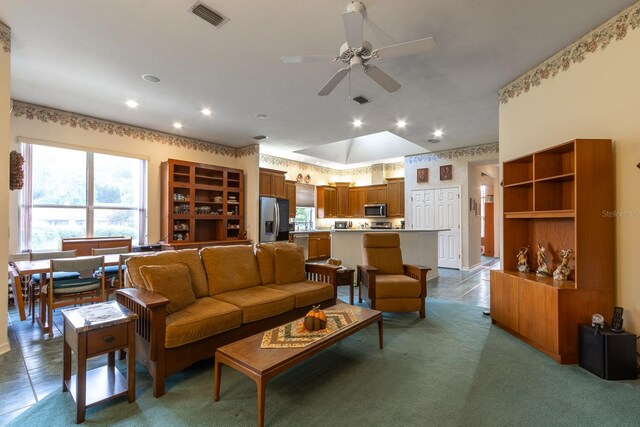 living room featuring ceiling fan and light carpet