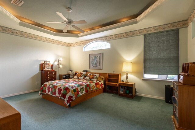 bedroom with ceiling fan, ornamental molding, and a raised ceiling