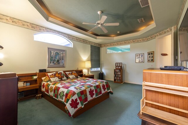 bedroom featuring ceiling fan, a raised ceiling, and dark colored carpet