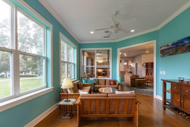 sunroom featuring ceiling fan