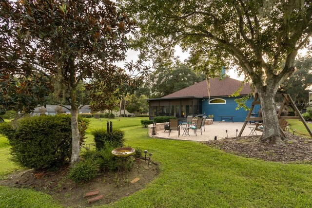 view of yard with a patio and a sunroom