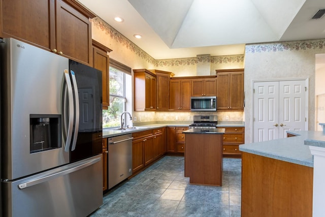 11509 NW 67th Ter, Alachua, FL 32615 - kitchen with brown cabinetry, a center island, appliances with stainless steel finishes, and a sink