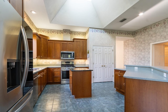 11509 NW 67th Ter, Alachua, FL 32615 - kitchen featuring a center island, visible vents, brown cabinets, and appliances with stainless steel finishes