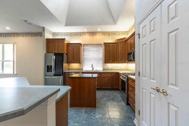 11509 NW 67th Ter, Alachua, FL 32615 - kitchen featuring brown cabinets, stainless steel appliances, backsplash, a sink, and a center island