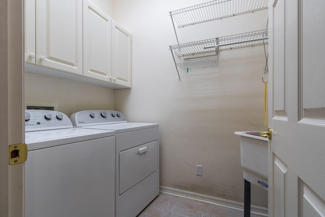 11509 NW 67th Ter, Alachua, FL 32615 - laundry room with baseboards, washer and dryer, light tile patterned floors, and cabinet space
