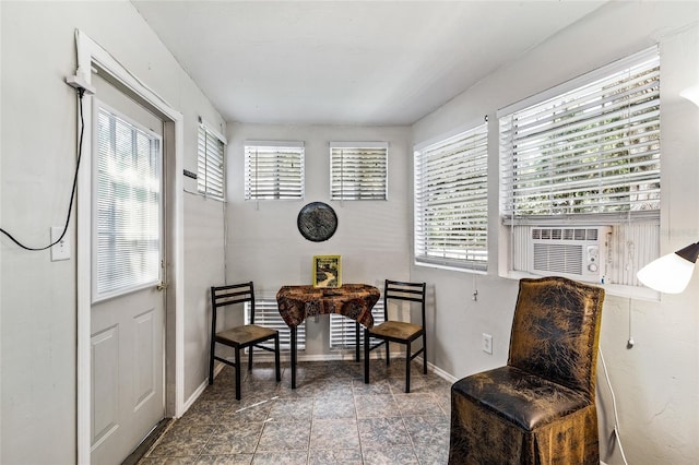 sitting room with cooling unit and baseboards