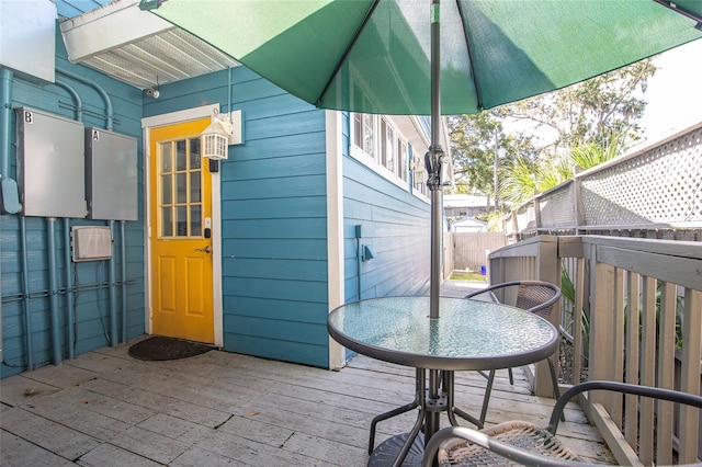 exterior space featuring outdoor dining space, fence, and a wooden deck