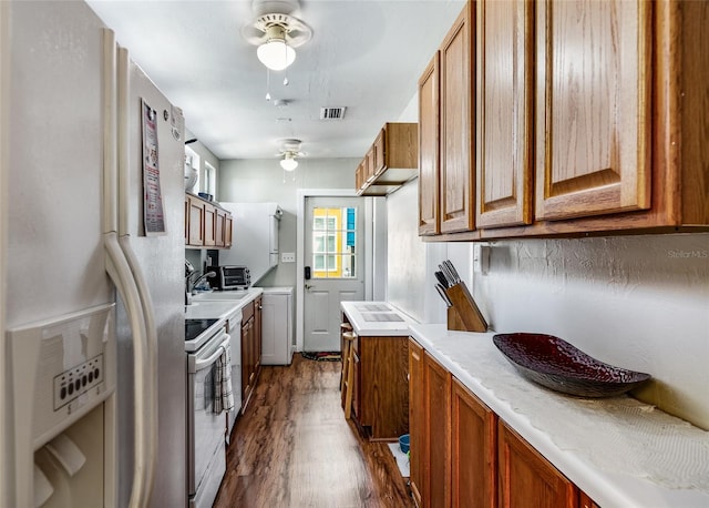 kitchen featuring dark wood-style floors, white range with electric stovetop, visible vents, light countertops, and refrigerator with ice dispenser