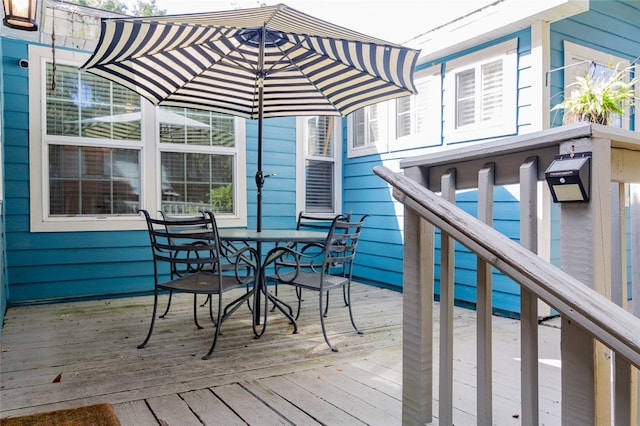 wooden deck featuring outdoor dining space