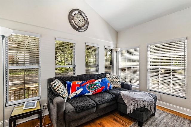 sunroom featuring vaulted ceiling and plenty of natural light