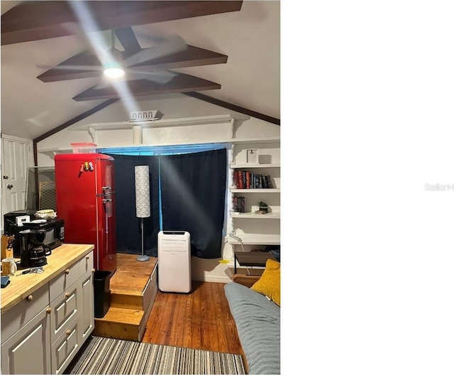 kitchen featuring lofted ceiling and wood finished floors