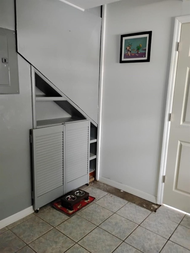 interior space with electric panel and baseboards