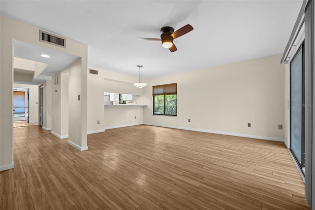 unfurnished living room featuring light wood-type flooring and ceiling fan