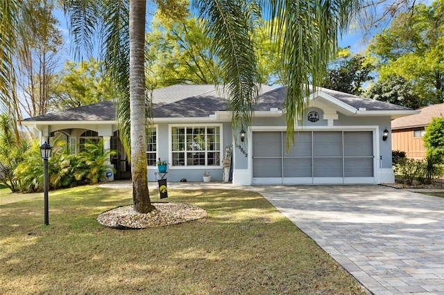 single story home with a garage and a front yard