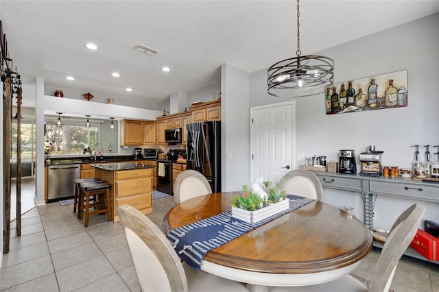 dining room with light tile patterned floors and a notable chandelier