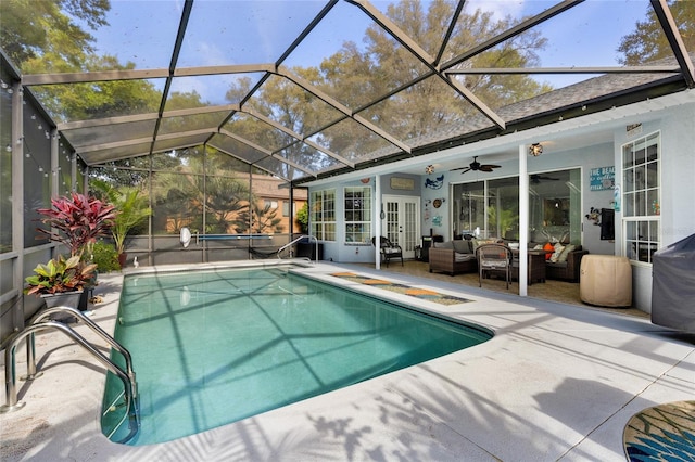 view of swimming pool featuring a lanai, ceiling fan, an outdoor living space, and a patio area