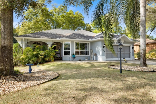 single story home featuring a garage and a front yard