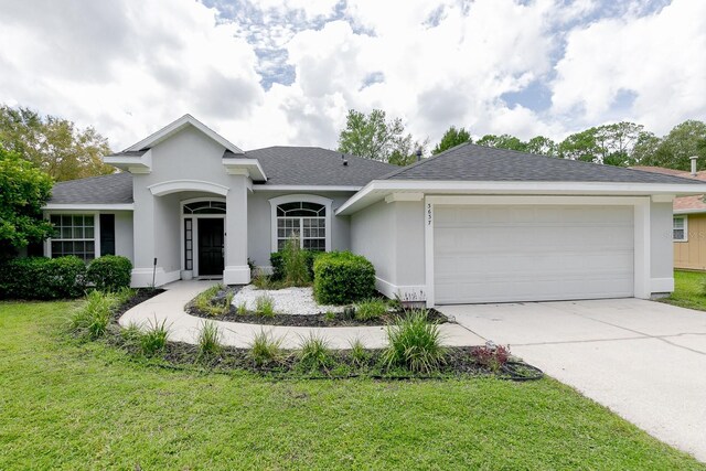 ranch-style home featuring a front yard and a garage