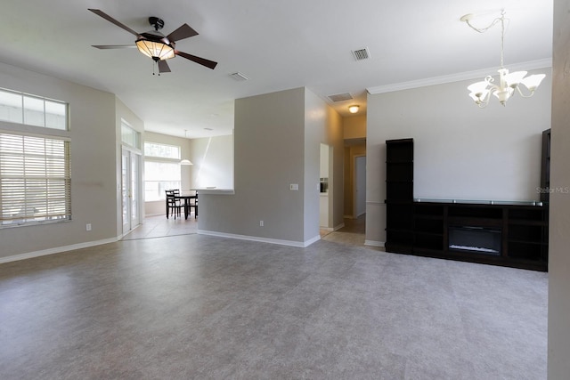 unfurnished living room featuring carpet, ceiling fan with notable chandelier, and ornamental molding