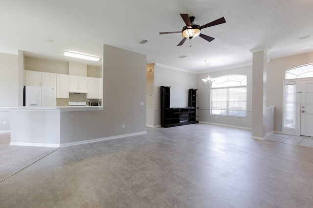 unfurnished living room with ceiling fan with notable chandelier and ornamental molding