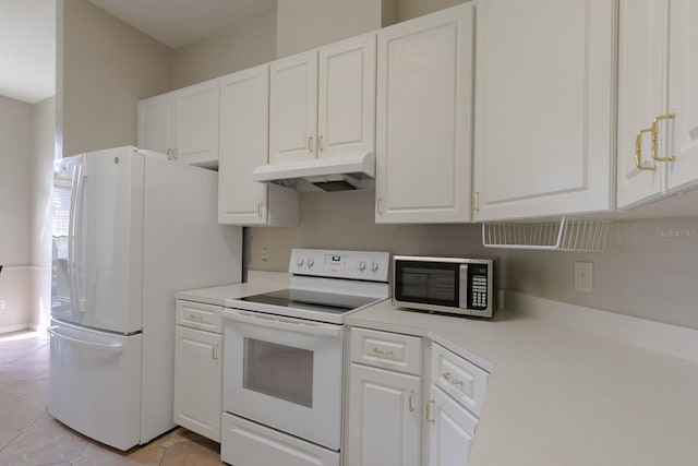 kitchen with light tile patterned floors, white appliances, and white cabinetry