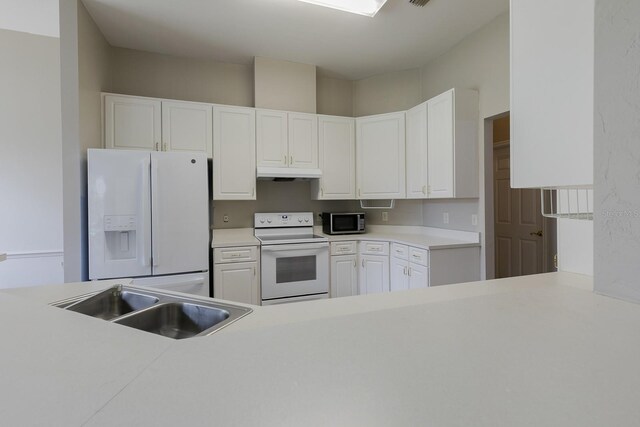 kitchen with white cabinetry, sink, and white appliances