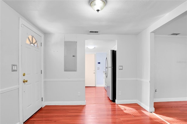 entryway with electric panel and hardwood / wood-style flooring