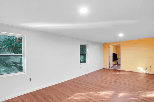 spare room featuring crown molding and wood-type flooring