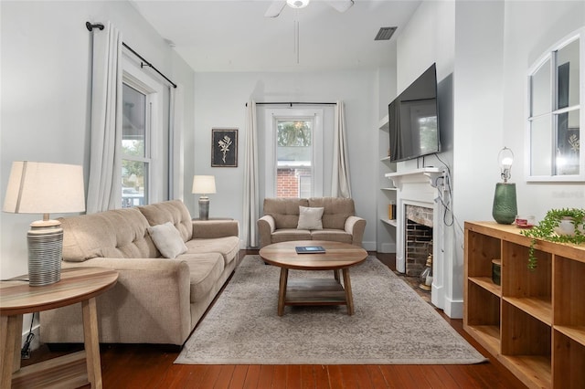 living room with dark hardwood / wood-style floors and ceiling fan