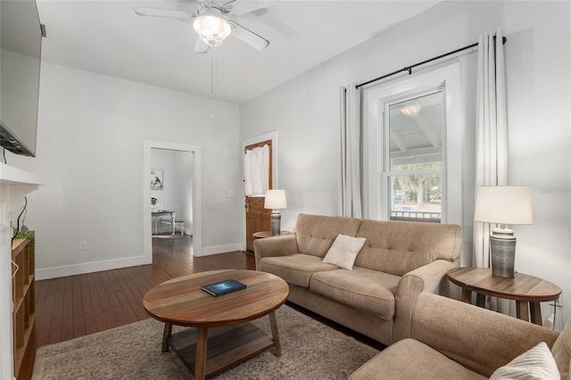 living room featuring ceiling fan and dark hardwood / wood-style flooring