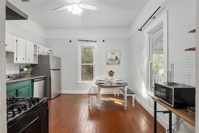 kitchen with appliances with stainless steel finishes, sink, white cabinets, dark hardwood / wood-style flooring, and green cabinetry