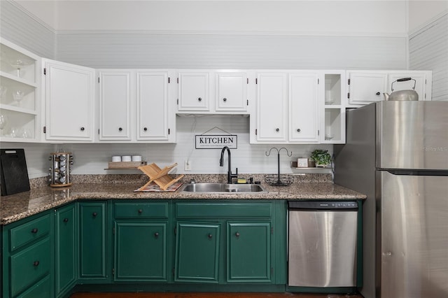 kitchen featuring white cabinetry, appliances with stainless steel finishes, sink, and dark stone counters