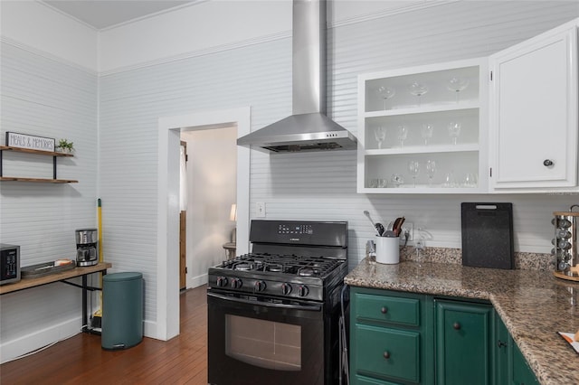 kitchen featuring white cabinets, black range with gas cooktop, green cabinets, and wall chimney range hood