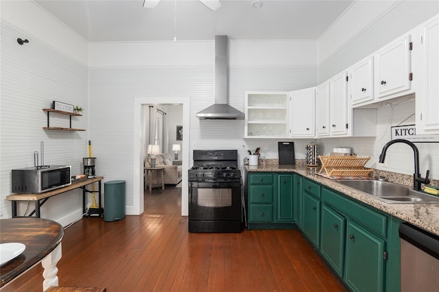 kitchen with sink, wall chimney range hood, appliances with stainless steel finishes, dark hardwood / wood-style floors, and green cabinetry