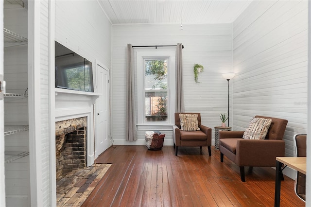 sitting room with dark hardwood / wood-style flooring