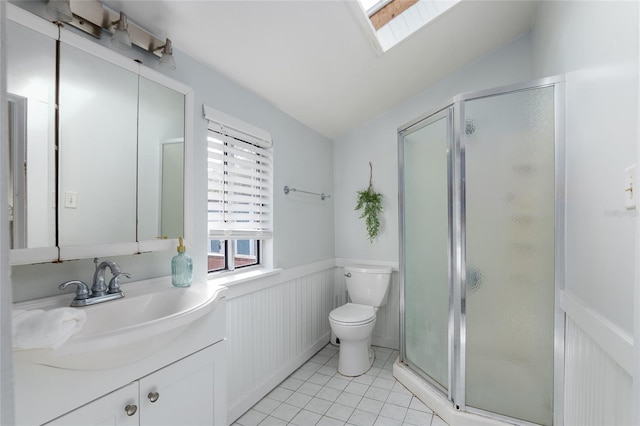 bathroom featuring tile patterned flooring, toilet, vaulted ceiling with skylight, and a shower with shower door