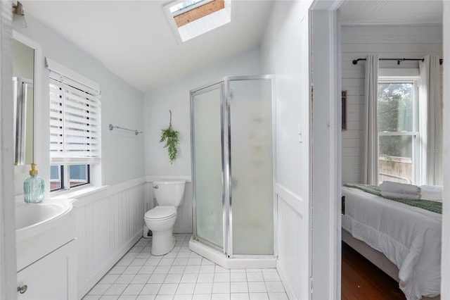 bathroom with lofted ceiling with skylight, toilet, tile patterned floors, and a shower with shower door