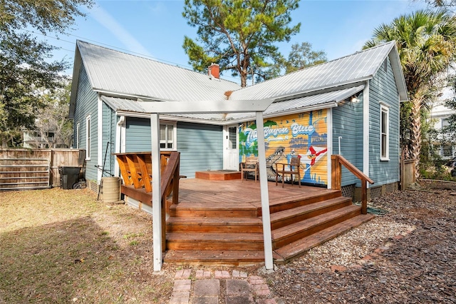 rear view of house featuring a deck