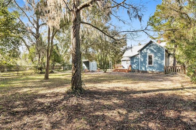 view of yard with a deck and a storage shed