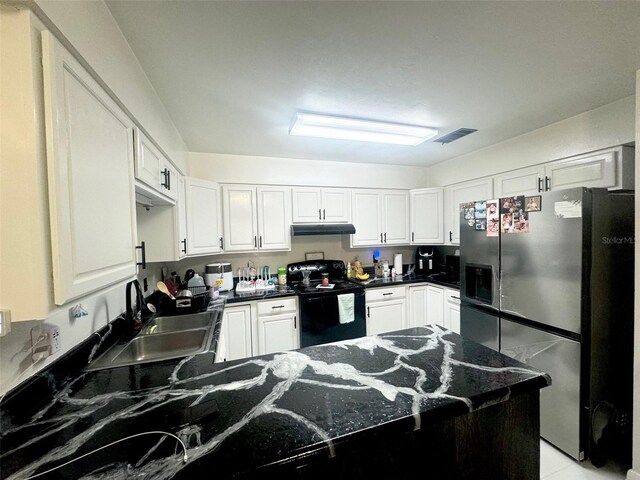 kitchen with white cabinets, dark stone countertops, sink, black electric range oven, and stainless steel fridge with ice dispenser