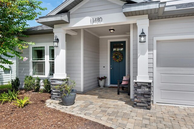 view of exterior entry with a garage