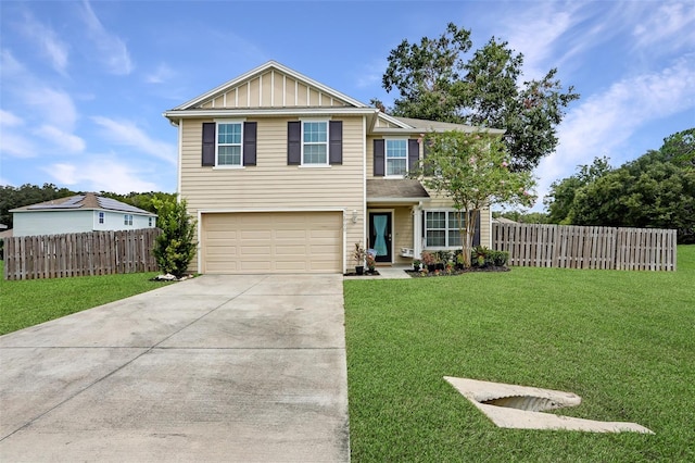 view of front of home featuring board and batten siding, concrete driveway, a front yard, and fence