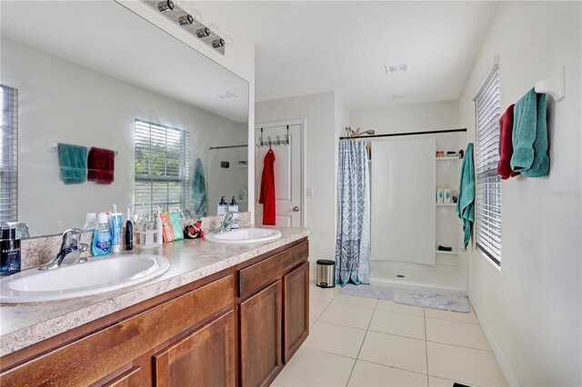 bathroom featuring tile patterned floors, walk in shower, and vanity