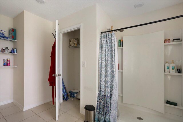 bathroom featuring tile patterned flooring and a shower with curtain