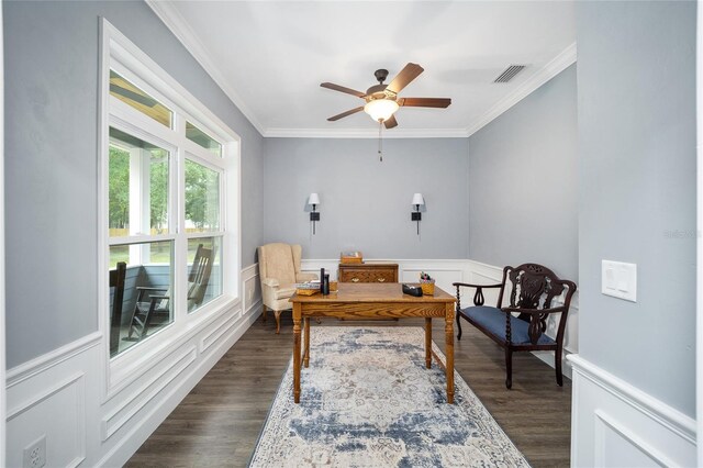 living area featuring dark wood-type flooring, ceiling fan, and ornamental molding